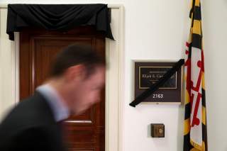 A man passes pass by the office of deceased Congressman Elijah Cummings (D-MD), on Capitol Hill, in Washington, U.S., October 17, 2019. REUTERS/Tom Brenner