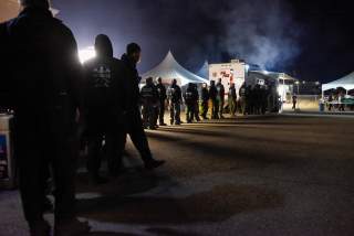 Firemen get dinner at the Cal Fire basecamp Mobile Kitchen Unit after a shift fighting the Kincaid Fire in Santa Rosa, California, U.S. October 26, 2019. Picture taken October 26, 2019. REUTERS/Kate Munsch