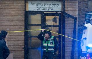 Emergency personnel and investigators work at the scene the day after an hours-long gun battle with two men around a kosher market in Jersey City, New Jersey, U.S., December 11, 2019. REUTERS/Lloyd Mitchell TPX IMAGES OF THE DAY