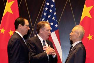 United States Trade Representative Robert Lighthizer gestures as he chats with Chinese Vice Premier Liu He with Treasury Secretary Steven Mnuchin, looking on after posing for a family photo at the Xijiao Conference Center in Shanghai, China, July 31, 2019