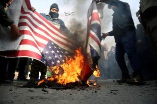 Demonstrators burn the U.S. and British flags during a protest against the assassination of the Iranian Major-General Qassem Soleimani, head of the elite Quds Force, and Iraqi militia commander Abu Mahdi al-Muhandis who were killed in an air strike