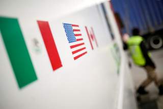 Flags of Mexico, United States and Canada are pictured at a security booth at Zaragoza-Ysleta border crossing bridge, in Ciudad Juarez, Mexico January 16, 2020. REUTERS/Jose Luis Gonzalez