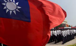 Members of the National Security Bureau take part in a drill next to a national flag at its headquarters in Taipei, Taiwan, November 13, 2015. REUTERS/Pichi Chuang