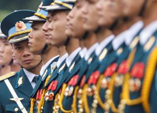 An officer checks the alignment of the honour guard before a welcoming ceremony for Japan's Prime Minister Shinzo Abe at the Presidential Palace in Hanoi, Vietnam January 16, 2017. REUTERS/Kham