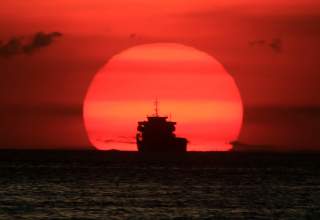 A cargo ship is silhouetted as the sun sets along the coast of Manila bay in Metro Manila, Philippines January 27, 2017. REUTERS/Romeo Ranoco