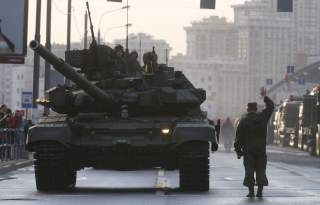 Russian servicemen are seen onboard a T-90 tank in a street before a rehearsal for the Victory Day parade in Moscow, Russia, April 29, 2015. Russia will celebrate the 70th anniversary of the victory over Nazi Germany in World War Two on May 9.