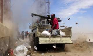 A Southern Popular Resistance fighter fires a weapon mounted on a truck during clashes with Houthi fighters in Yemen's southern city of Aden May 3, 2015. Between 40-50 Arab special forces soldiers arrived in Aden on Sunday and deployed alongside local fig