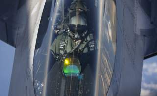 The head-up display of a F-22 Raptor fighter jet reflects the sun light as a pilot of the 95th Fighter Squadron from Tyndall, Florida is seen during refuelling by a KC-135 Stratotanker from the 100th Air Refueling Wing at the Royal Air Force Base in Milde