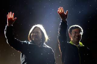 Taiwan's Democratic Progressive Party (DPP) Chairperson and presidential candidate Tsai Ing-wen (L) and vice presidential candidate Chen Chien-jen greet supporters as they take the stage during a final campaign rally ahead of the elections in Taipei, Taiw