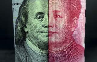 A U.S. 100-dollar banknote with a portrait of Benjamin Franklin and a Chinese 100-yuan banknote with a portrait of late Chinese Chairman Mao Zedong are seen in the picture illustration in Beijing, China, January 21, 2016.