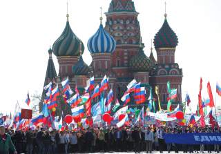 People walk with flags at Red Square during a May Day rally in Moscow, Russia, May 1, 2016. REUTERS/Maxim Zmeyev