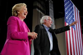 U.S. Democratic presidential nominee Hillary Clinton and U.S. Senator Bernie Sanders take the stage at a campaign rally in Raleigh, North Carolina, U.S. November 3, 2016. REUTERS/Brian Snyder