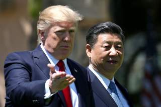 U.S. President Donald Trump and China's President Xi Jinping chat as they walk along the front patio of the Mar-a-Lago estate after a bilateral meeting in Palm Beach, Florida, U.S., April 7, 2017. REUTERS/Carlos Barria