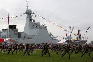 People's Liberation Army Navy soldiers perform in front of destroyer Yinchuan at a naval base in Hong Kong, China July 8, 2017. REUTERS/Bobby Yip