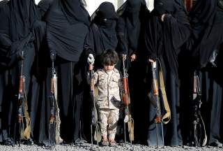 A boy stands with women loyal to the Houthi movement during a gathering held to show their support to the movement in Sanaa, Yemen January 14, 2018. REUTERS/Khaled Abdullah TPX IMAGES OF THE DAY