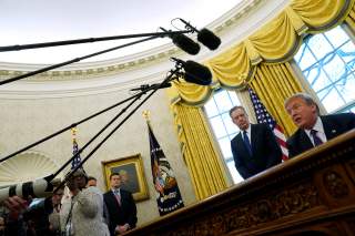 U.S. Trade Representative Robert Lighthizer stands behind U.S. President Donald Trump as Trump prepares to sign directives to impose tariffs on imported washing machines and solar panels in the Oval Office at the White House in Washington, U.S. January 23