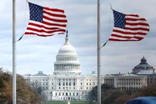 American flags fly on National Mall with U.S. Capitol on background as high-wind weather conditions continue in Washington, U.S. March 2, 2018. REUTERS/Yuri Gripas