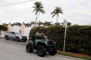 A police officer secures the entrance to U.S. President Donald Trump's Mar-a-Lago estate in Palm Beach, Florida, U.S., March 31, 2018. REUTERS/Yuri Gripas