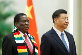 Chinese President Xi Jinping and President of Zimbabwe Emmerson Mnangagwa attend a welcoming ceremony before talks at the Great Hall of the People in Beijing, China April 3, 2018. REUTERS/Thomas Peter