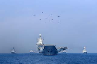 Warships and fighter jets of Chinese People's Liberation Army (PLA) Navy take part in a military display in the South China Sea April 12, 2018. Picture taken April 12, 2018. REUTERS/Stringer