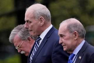 White House Chief of Staff John Kelly, White House chief economic adviser Larry Kudlow (R) and new National Security Advisor John Bolton (L) leave the Oval Office as U.S. President Donald Trump departs the White House for a trip to Miami, Florida, in Wash