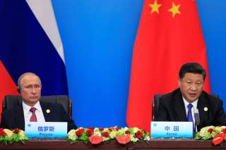 China's President Xi Jinping and Russia's President Vladimir Putin attend a signing ceremony during Shanghai Cooperation Organization (SCO) summit in Qingdao, Shandong Province, China June 10, 2018. REUTERS/Aly Song