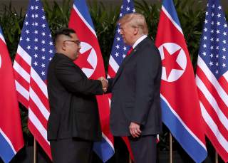 U.S. President Donald Trump shakes hands with North Korean leader Kim Jong Un at the Capella Hotel on Sentosa island in Singapore June 12, 2018. REUTERS/Jonathan Ernst