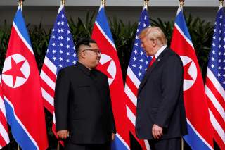 U.S. President Donald Trump and North Korea's leader Kim Jong Un meet at the Capella Hotel on the resort island of Sentosa, Singapore June 12, 2018. REUTERS/Jonathan Ernst