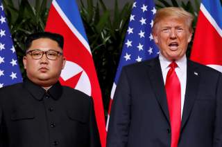 U.S. President Donald Trump and North Korean leader Kim Jong Un react at the Capella Hotel on Sentosa island in Singapore June 12, 2018. REUTERS/Jonathan Ernst TPX IMAGES OF THE DAY