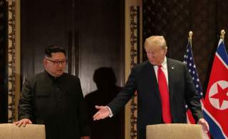 U.S. President Donald Trump and North Korea's leader Kim Jong Un arrive to sign a document to acknowledge the progress of the talks and pledge to keep momentum going, after their summit at the Capella Hotel on Sentosa island in Singapore June 12, 2018. RE