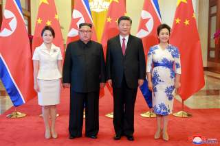 North Korean leader Kim Jong Un and his wife Ri Sol Ju pose beside Chinese President Xi Jinping and his wife Peng Liyuan in Beijing, China, in this undated photo released June 20, 2018 by North Korea's Korean Central News Agency.