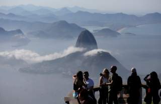 Tourists are seen with the Sugarloaf Mountain in the background in Rio de Janeiro, Brazil June 21, 2018. REUTERS/Bruno Kelly