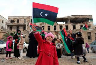 A child carries the flag of Libya during a celebration of the eighth anniversary of the revolution, in Benghazi, Libya February 17, 2019. REUTERS/Esam Omran Al-Fetori