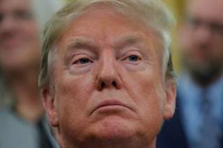 U.S. President Donald Trump looks on as he participates in a signing ceremony of 