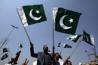 People carry national flags as they celebrate, after Pakistan shot down two Indian military aircrafts, in Lahore, Pakistan February 27, 2019. REUTERS/Mohsin Raza