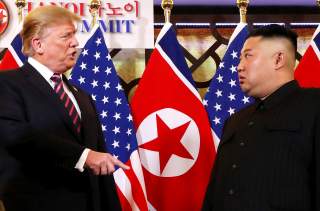 U.S. President Donald Trump speaks to North Korean leader Kim Jong Un after shaking hands before their one-on-one chat during the second U.S.-North Korea summit at the Metropole Hotel in Hanoi, Vietnam February 27, 2019. REUTERS/Leah Millis