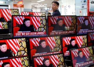 A clerk watches a set of TV's broadcasting a news report on a Hanoi summit between North Korean leader Kim Jong Un and U.S. President Donald Trump, in Seoul, South Korea, February 28, 2019. REUTERS/Kim Hong-Ji