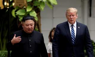 FILE PHOTO: North Korea's leader Kim Jong Un and U.S. President Donald Trump talk in the garden of the Metropole hotel during the second North Korea-U.S. summit in Hanoi, Vietnam February 28, 2019. REUTERS/Leah Millis/File Photo