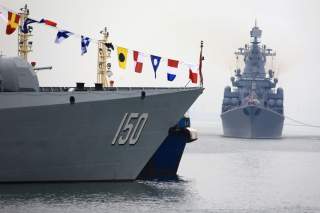 Russia Navy's guided missile cruiser Varyag (R) arrives for the Chinese-Russian joint naval exercise, near a guided missile destroyer Changchun (DDG150) of Chinese People's Liberation Army (PLA) Navy, at Dagang port, in Qingdao, Shandong province, China A