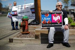 Uber and Lyft drivers protest during a day-long strike outside Uber’s office in Saugus, Massachusetts, U.S., May 8, 2019. REUTERS/Brian Snyder