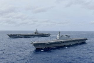 The Navy's forward-deployed aircraft carrier USS Ronald Reagan operates with the Japan Maritime Self-Defense Force helicopter carrier JS Izumo (R) in South China Sea June 11, 2019. Picture taken June 11, 2019. Courtesy JMSDF/U.S. Navy/Handout via REUTERS