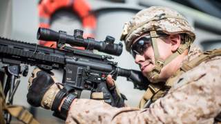 A U.S. Marine Corps rifleman with Kilo Company, Battalion Landing Team 3/5, provides security with an M27 Infantry Automatic Rifle on aboard the amphibious assault ship USS Boxer (LHD 4) during its transit through Strait of Hormuz in Gulf of Oman