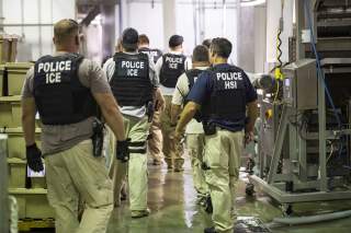 Homeland Security Investigations (HSI) officers from Immigration and Customs Enforcement (ICE) look on after executing search warrants and making some arrests at an agricultural processing facility in Canton, Mississippi, U.S. in this August 7, 2019 hando