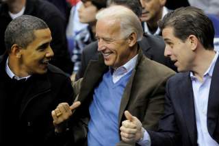 U.S. President Barack Obama, Vice President Joe Biden and his son Hunter Biden attend an NCAA basketball game between Georgetown University and Duke University in Washington, U.S., January 30, 2010. Picture taken January 30, 2010. REUTERS/Jonathan Ernst