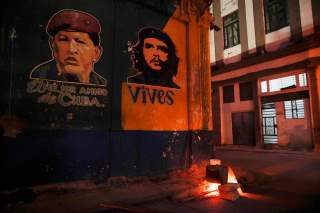 Images depicting Venezuela's late president Hugo Chavez (L), with words that read 