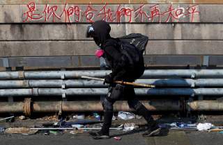 A protester walks at the occupied campus of the Chinese University in Hong Kong, China, November 13, 2019. REUTERS/Thomas Peter