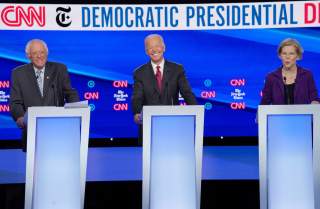  Democratic presidential candidates Senator Bernie Sanders and former Vice President Joe Biden listen to Senator Elizabeth Warren as they debate during the fourth U.S. Democratic presidential candidates 2020 election debate in Westerville, Ohio