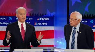 Democratic presidential candidate former Vice President Joe Biden speaks as Senator Bernie Sanders listens during the fifth 2020 campaign debate at the Tyler Perry Studios in Atlanta, Georgia, U.S., November 20, 2019. REUTERS/Brendan McDermid