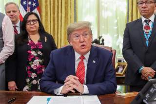 U.S. President Donald Trump speaks while signing an Executive Order 