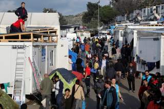 Refugees and migrants make their way inside the Moria camp, on the island of Lesbos, Greece, November 27, 2019. REUTERS/Elias Marcou